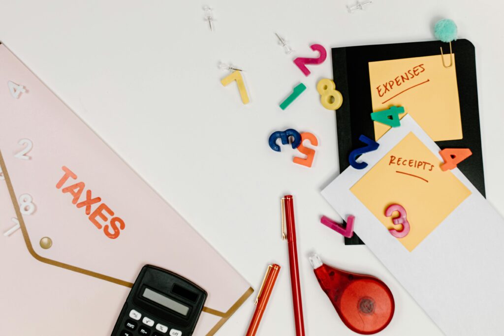 pexels photo 7111519 7111519 Flat lay of tax documents, receipts, calculator, and colorful numbers for budgeting.